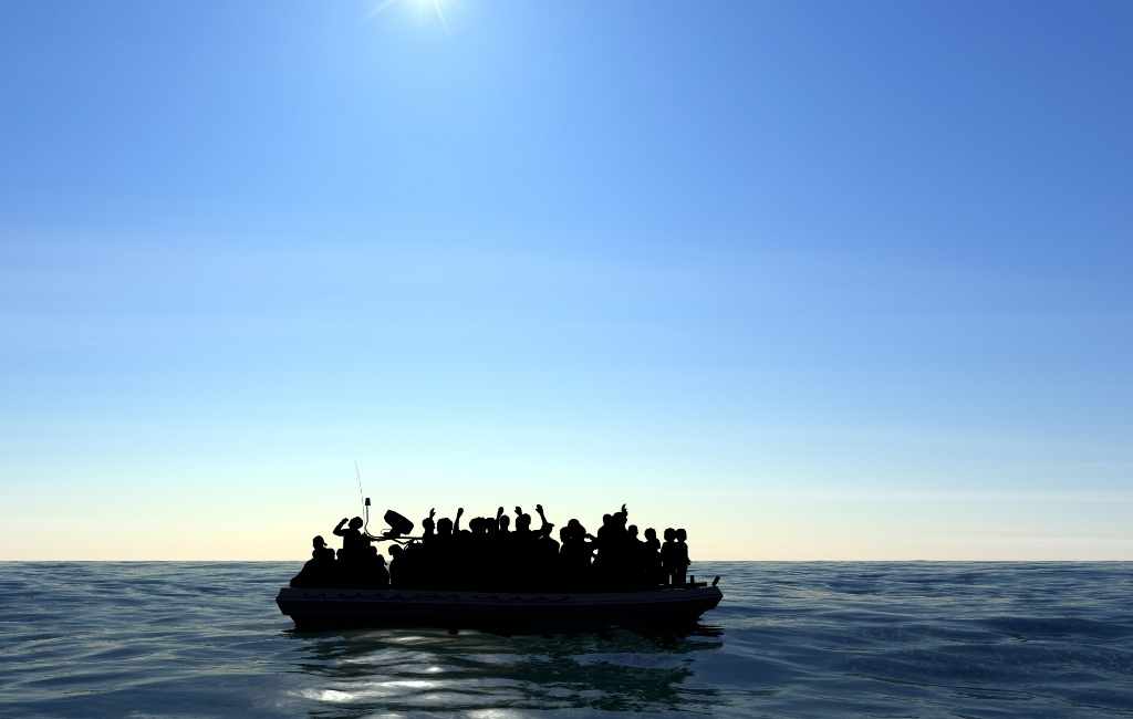 Refugees on board on a small boat on the mediterranean sea trying to flee ome countries and reach safer countries.